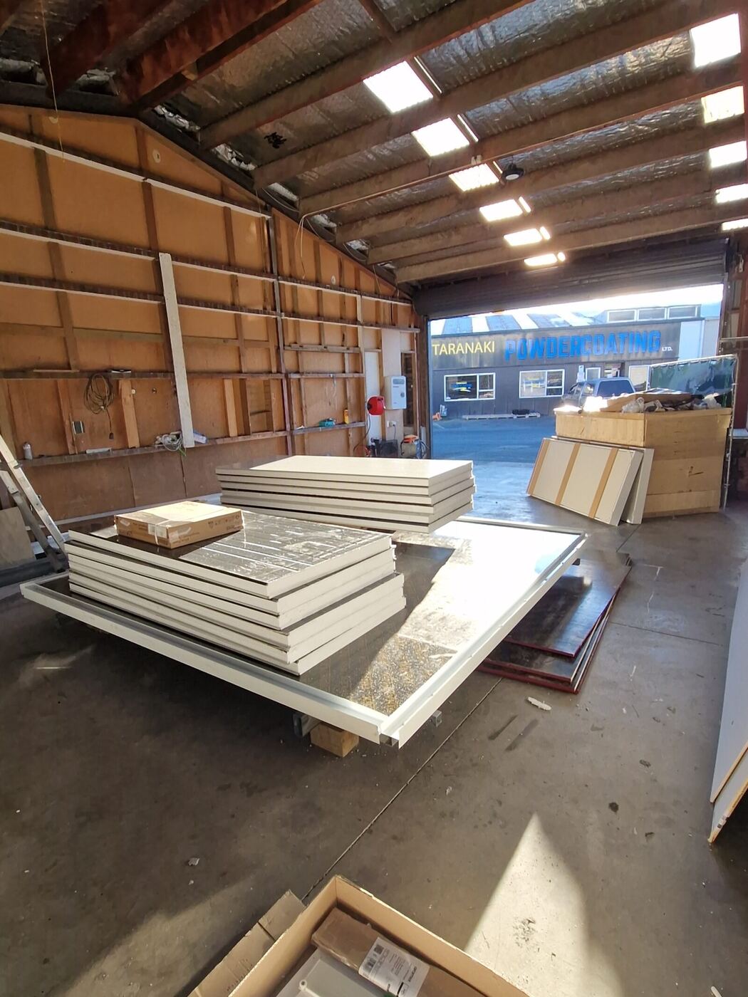 Insulated wall panels stacked in the Bell Block workshop, ready to load
