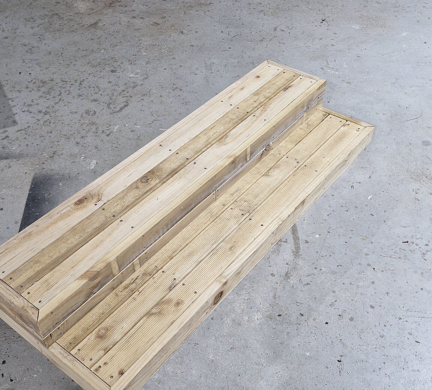A set of portable timber stairs on the workshop floor